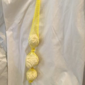 White prill beads in yellow netting