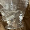 Two sealed, quart sized bags of Ellis Water